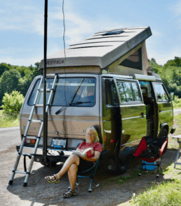 Louise, VE3LOI, taking a break by the mobile station in the Westy at the Rideau Lakes Cycle Tour 2025